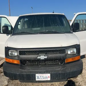 2015 Chevrolet G33405 cargo van. Features 6.0 Vortec engine, interior cargo shelving, and rear hitch receiver. Mileage: 334,189. GVWR: 9,600 lbs. Tire