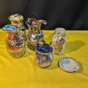 Jars Filled With Jewelry Including Necklaces, Bracelets, Watches, and More