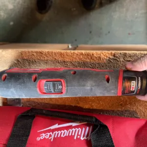 Milwaukee M12 cordless multi-tool with 12V Lithium-Ion battery, charger, and Milwaukee branded carry