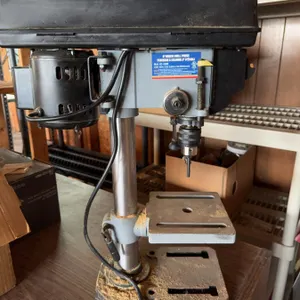 King Canada drill press with metal construction and wired motor. Also contains various hand tools, a