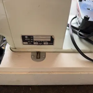 Domestic brand sewing machine, model 915, includes original owner's manual and carrying case. Operat