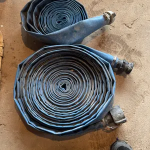 Lot consists of two blue layflat water hoses with attached metal couplings. The hoses are coiled and