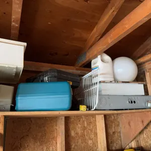 All items located in the corner, including various containers, household equipment, and miscellaneou