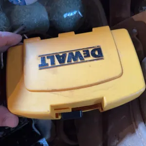 DeWalt screwdriver bit set in yellow case, a metal drill bit set in red case, a torque wrench, and v