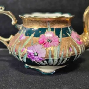 Porcelain creamer, handpainted, possibly Mignon Co