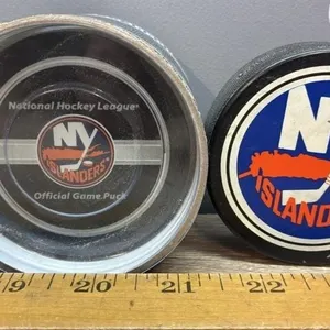2 NY Islanders Hockey Pucks - One Official Game