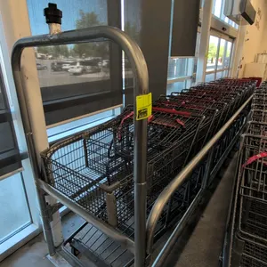 Single-lane metal cart corral. Features tubular metal construction. 14'L x 3'W x 6.5'H. Note: carts not included.