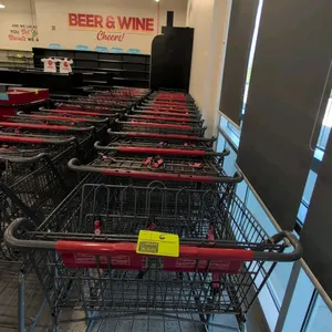 Metal shopping cart. Features a wire basket, red handle, child seating area with safety straps, and a lower storage rack. 42" x 30". Mounted on caster