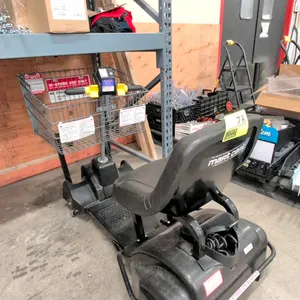 Mart Cart XTi12 electric shopping cart. Features a wire front basket, black vinyl seat, and handlebar controls. Includes an integrated power cord. Mou