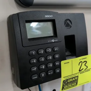 Pyramid 9600 biometric fingerprint time clock. Features LCD display, keypad, and fingerprint scanner. Wall-mounted.