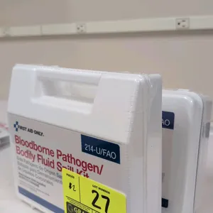 First Aid Only 214-U/FAO bloodborne pathogen and bodily fluid spill kit. Features a 23-piece set enclosed in a white plastic case with a handle. Meets