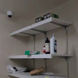 3-tier wall-mounted shelving unit. Features white laminate shelves and metal mounting brackets. 48"W x 16"D x 36"H. Contents not included.