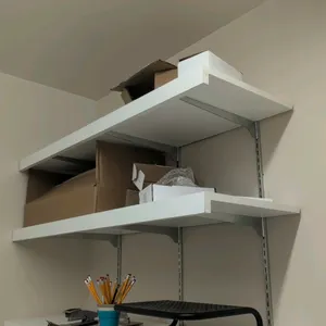 3-tier wall-mounted shelving unit. Features white laminate shelves and metal brackets. 48"L x 16"D x 36"H. Contents not included.