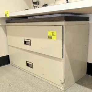 2-drawer metal lateral filing cabinet. Features a wood-look laminate top. 42"W x 18"D x 27"H.