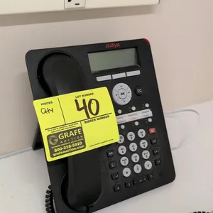 Avaya 1408 digital desk phone. Features an LCD display, handset, and push-button dial pad. S/N: 18WZ34400E19.