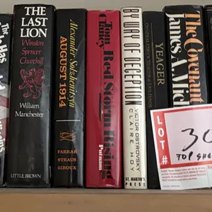 Hardback books on top shelf
