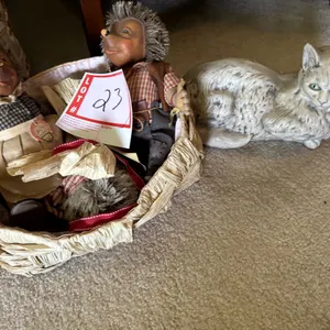 Basket with hedgehogs and cat statue