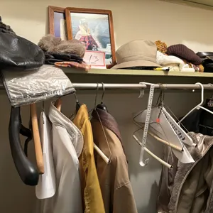 Contents of closet, boots, jackets, hats, picture frames
