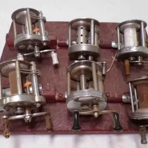 6 Baitcasting Fishing Reels Zip Tied to Display