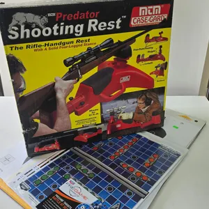 MTM Predator shooting rest in original box and an assortment of targets