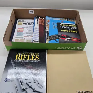 Selection of reference books including Checkering and Carving Gun Stocks, Nine mm pistol cartridges 