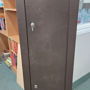 Eight gun cabinet w/ one shelf and a large hand gun case. Measures 55" H x 1" W 10" D