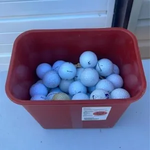 Bin of golf balls and tees