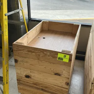 Wood produce dump table. Features wood plank side construction with a faux wood grain laminate bottom panel and a pre-drilled center hole. Designed fo