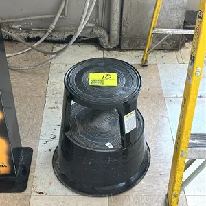 Vestil plastic step stool. Features a 2-step design with molded circular traction treads. Constructed of black polyethylene.