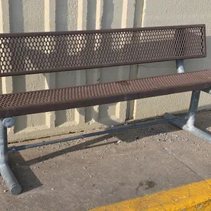 Metal park bench. Features an expanded metal seat and backrest with a brown protective coating. Mounted on a galvanized steel pipe frame with a freest