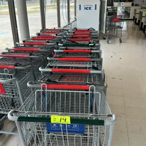 Metal grocery shopping cart. Features durable wire basket construction, plastic handle sleeve, integrated folding child seat with safety restraint str