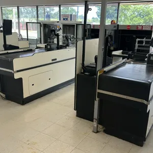 Laminate check lane. Features an 8'L layout with a 3' motorized conveyor belt. Includes a bagging section with a wire bag rack and integrated shelving