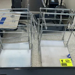 Chrome wire grocery bag dispensing stand. Features durable chrome-plated wire construction with hooks for T-shirt style shopping bags and a plastic bo