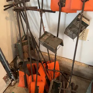 Bag of metal casters with mounting plates, several large metal pipe wrenches, hand tools, and multip