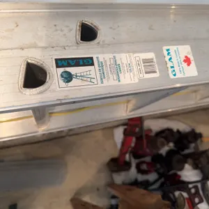 GLAM extension ladder made of aluminum. Features labels indicating manufacturer and origin. Designed