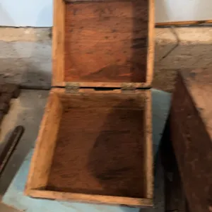 Several assorted wooden boxes, some with hinges and hooks. One box features partial labeling for Gil