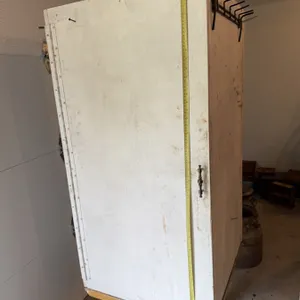 Wooden storage cabinet featuring five metal shelves mounted on the interior sides, with a metal hand