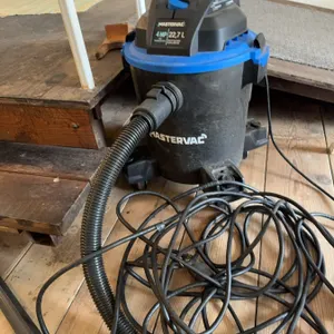 Mastervac wet/dry vacuum with 4 HP motor and 22.7 liter capacity. Features include a black body with