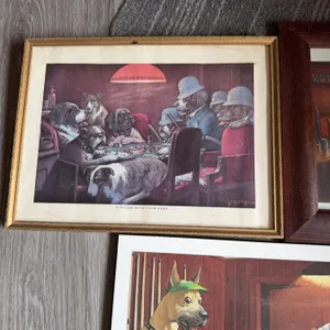 Three framed prints and paintings featuring dogs in humorous, anthropomorphic settings. One print po