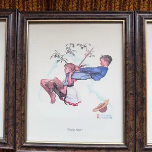 Four framed Norman Rockwell prints: "Mysterious Malady," "Downhill Daring," "Flying High," and "Adve