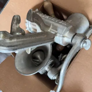Various hand tools with wood handles such as brace drills, a manual meat grinder, and additional mix
