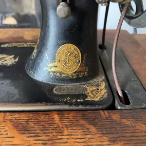 Singer treadle sewing machine, serial number 16165557, featuring original cast iron base and wooden 