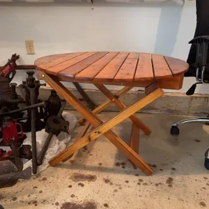 Round folding table made of wood, measuring approximately 32 inches in diameter and 28 inches in hei