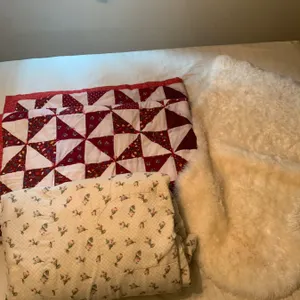 Three:Handmade Patchwork Quilt, Floral Comforter, and Sheepskin Rug