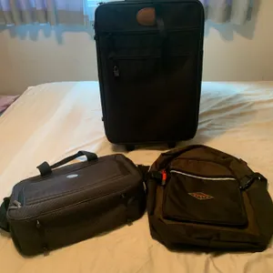 Three Travel Bags Including Suitcase, Carry-On Bag, and Backpack