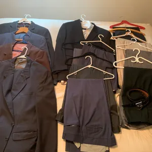 Mens Vintage Suit Collection with Multiple Jackets, Pants, and Accessories