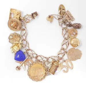 10KT GOLD CHARM BRACELET W/ 19 CHARMS $6,070