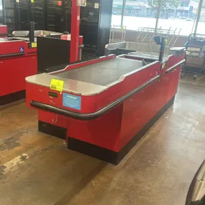 Royston UL-6-55-RH-1 single belt checkout lane. Features red metal construction, bumper guards, bagging area with wire bag racks, and under-counter st