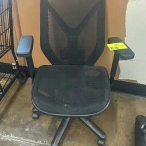 Mesh office chair. Features a black mesh seat and back with a Y-shaped back support frame and adjustable T-armrests. Mounted on a black 5-star base wi