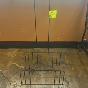 Metal shopping basket stand. Features black wire construction and a tall integrated loop handle. Note: Baskets not included.